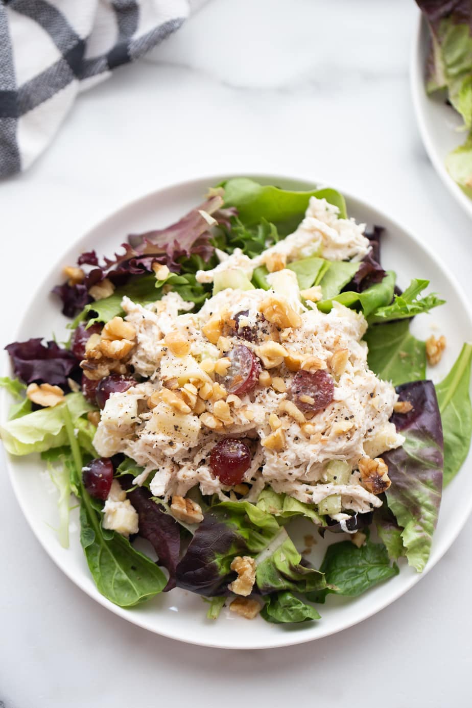 Plate of healthy chicken salad over a bed of lettuce.
