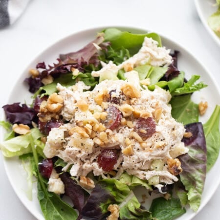 Plate of healthy chicken salad over a bed of lettuce.