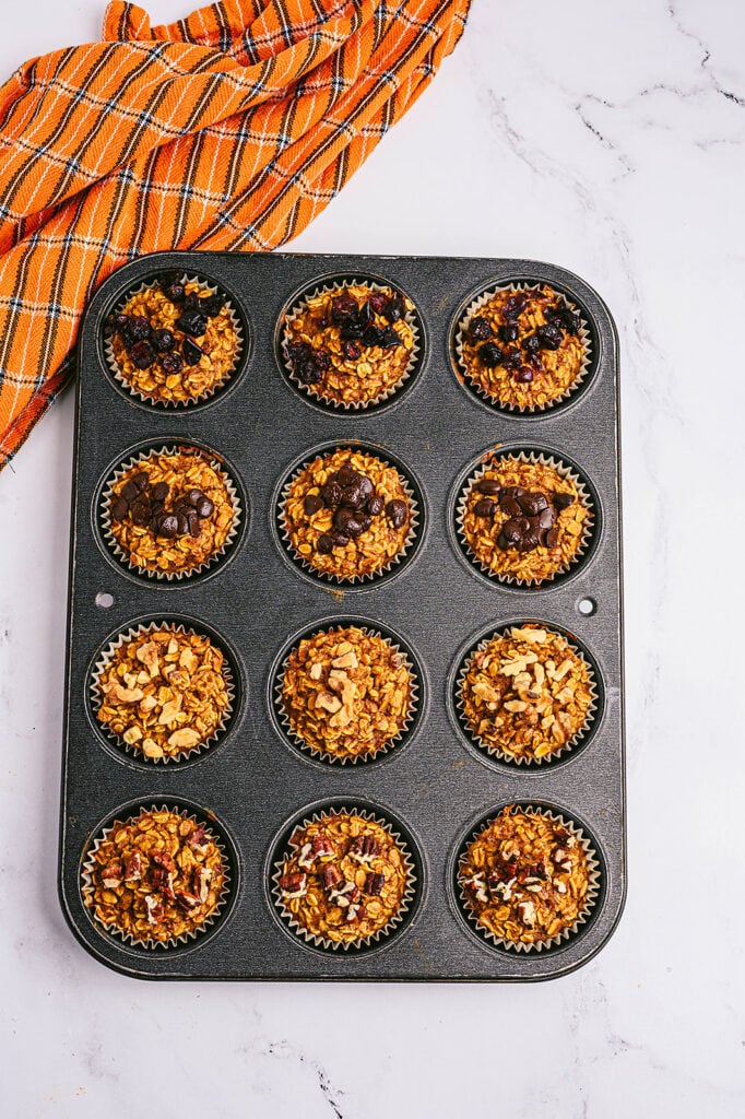 Overhead photo: pumpkin oatmeal muffins in a muffin tin, straight from the oven