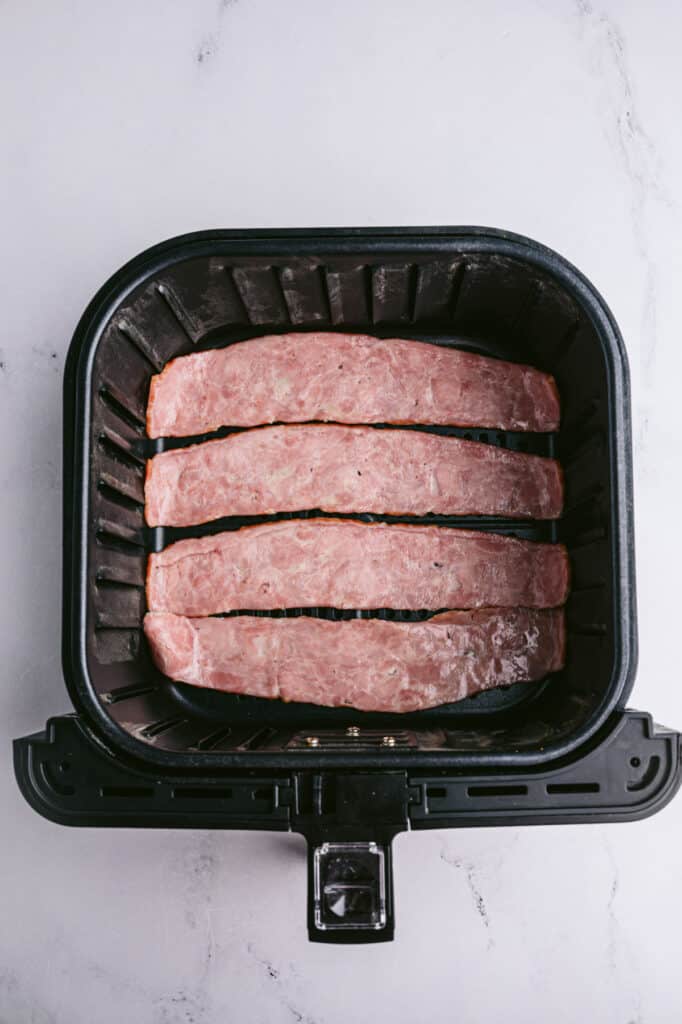 Four strips of turkey bacon in an air fryer 