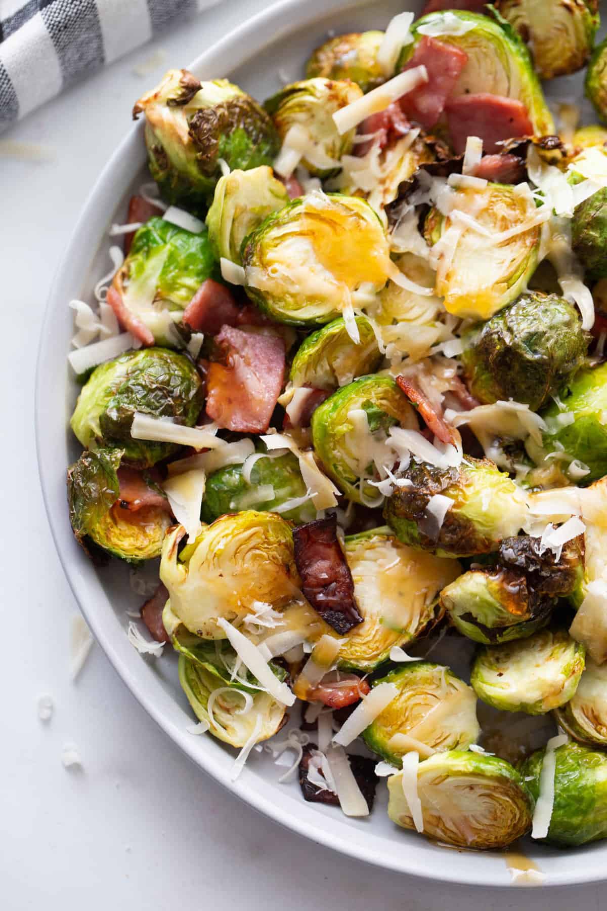 Air Fried Brussels Sprouts with parmesan cheese, turkey bacon, and hot honey.