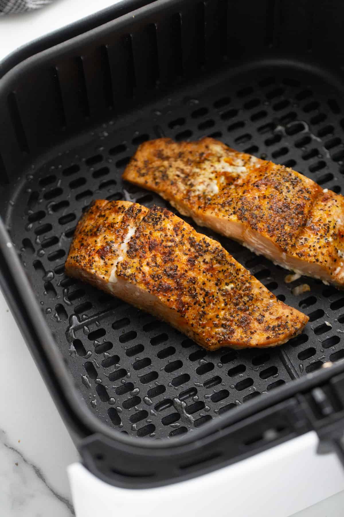 Cooked Air Fryer Salmon in an Air Fryer Basket. 