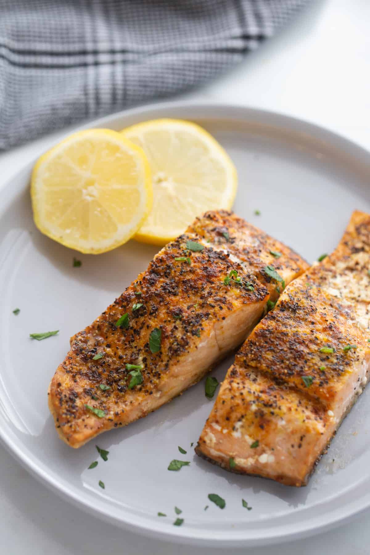 Frozen Salmon filets made in the air fryer with lemon pepper seasoning and paprika. 