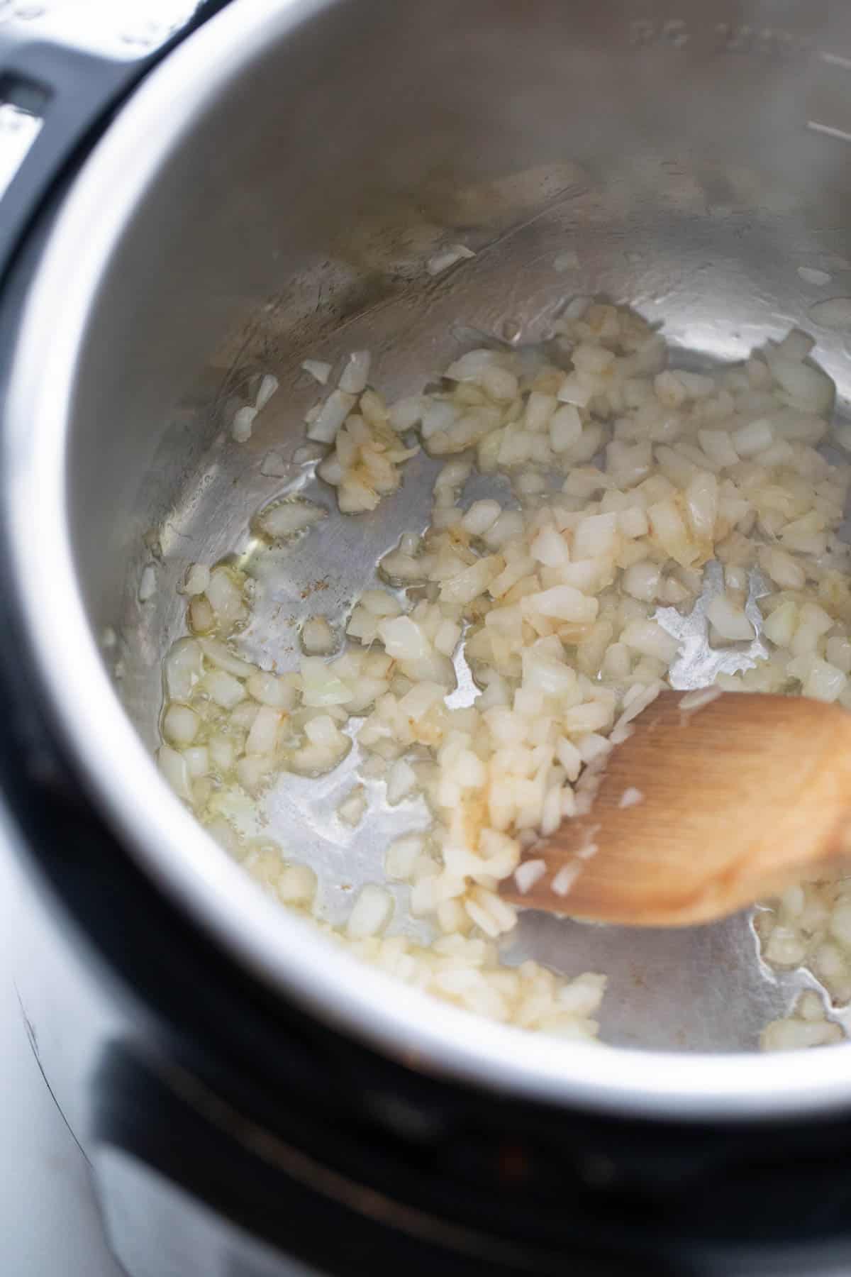 Sauteed onions, garlic, and ginger in an instant pot. 