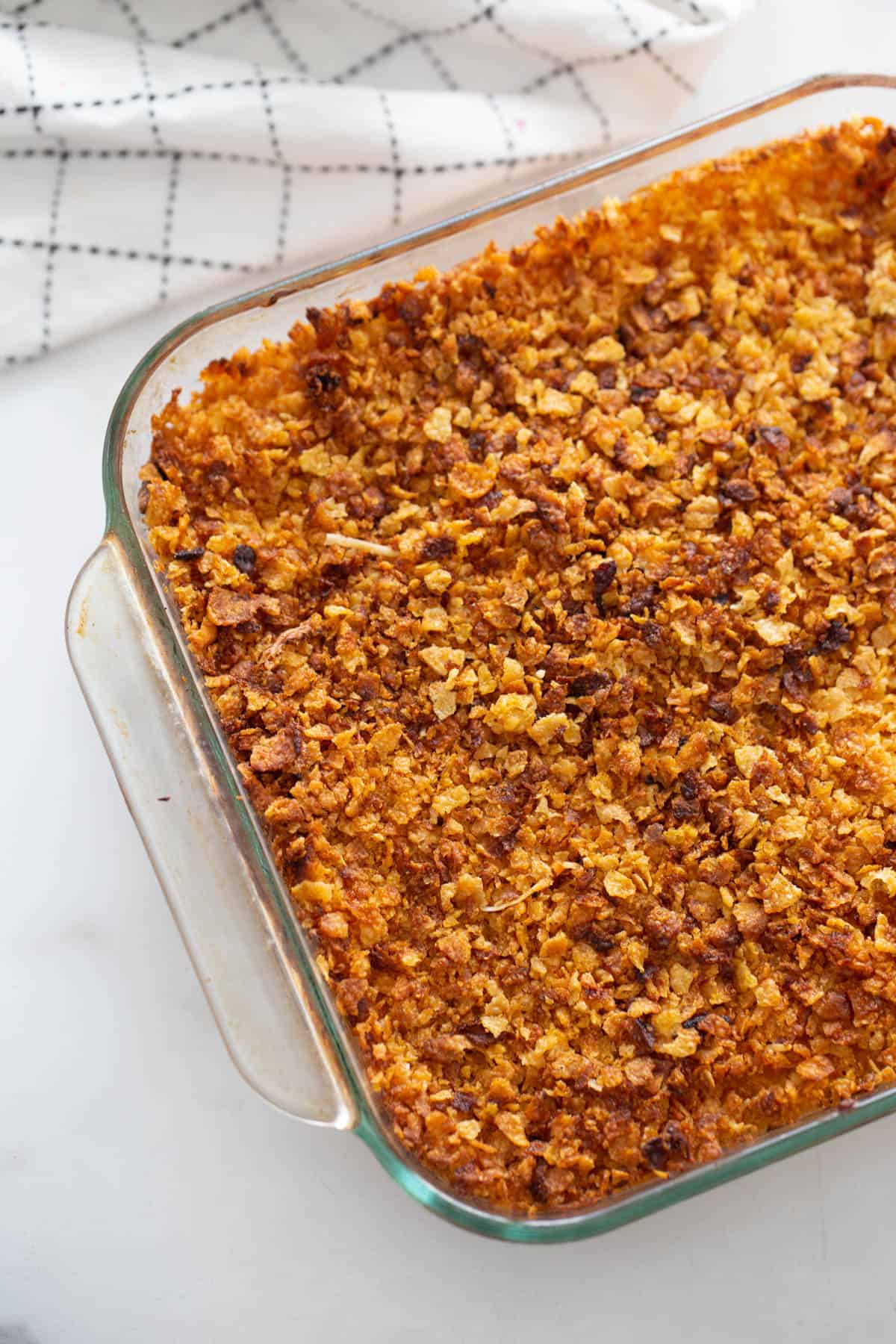 A baking dish with healthier cheesy hash brown casserole