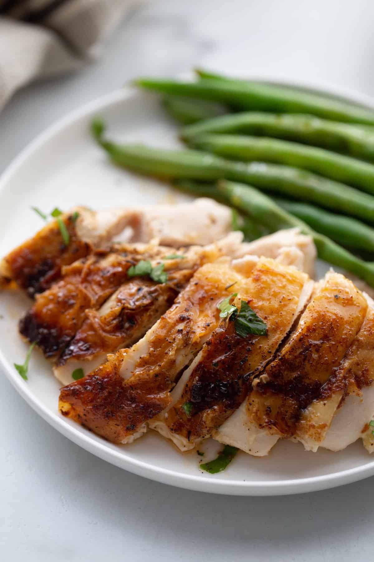 Sliced chicken breast with green beans.