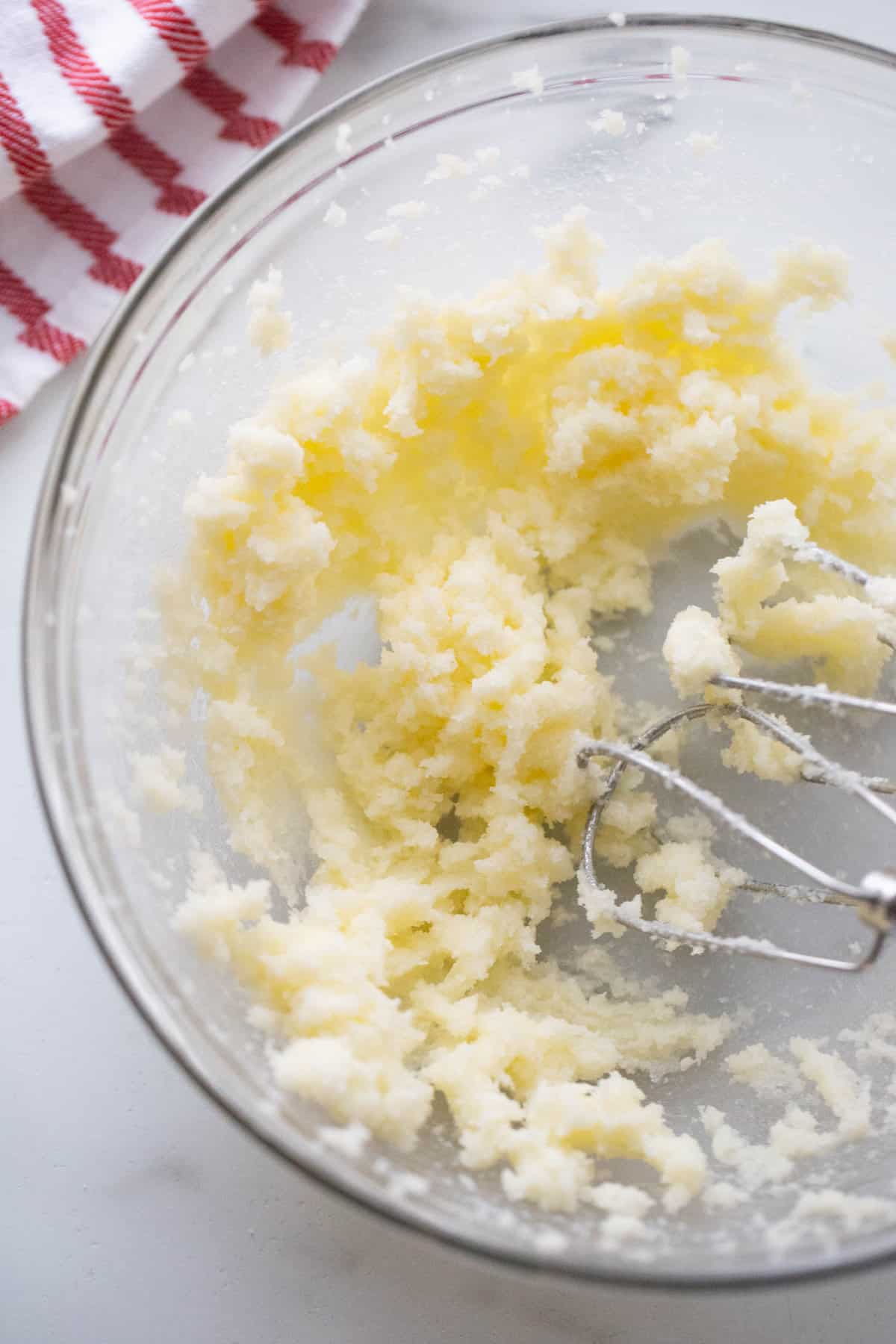 A hand mixer mixing up dairy free butter and sugar for cookies.
