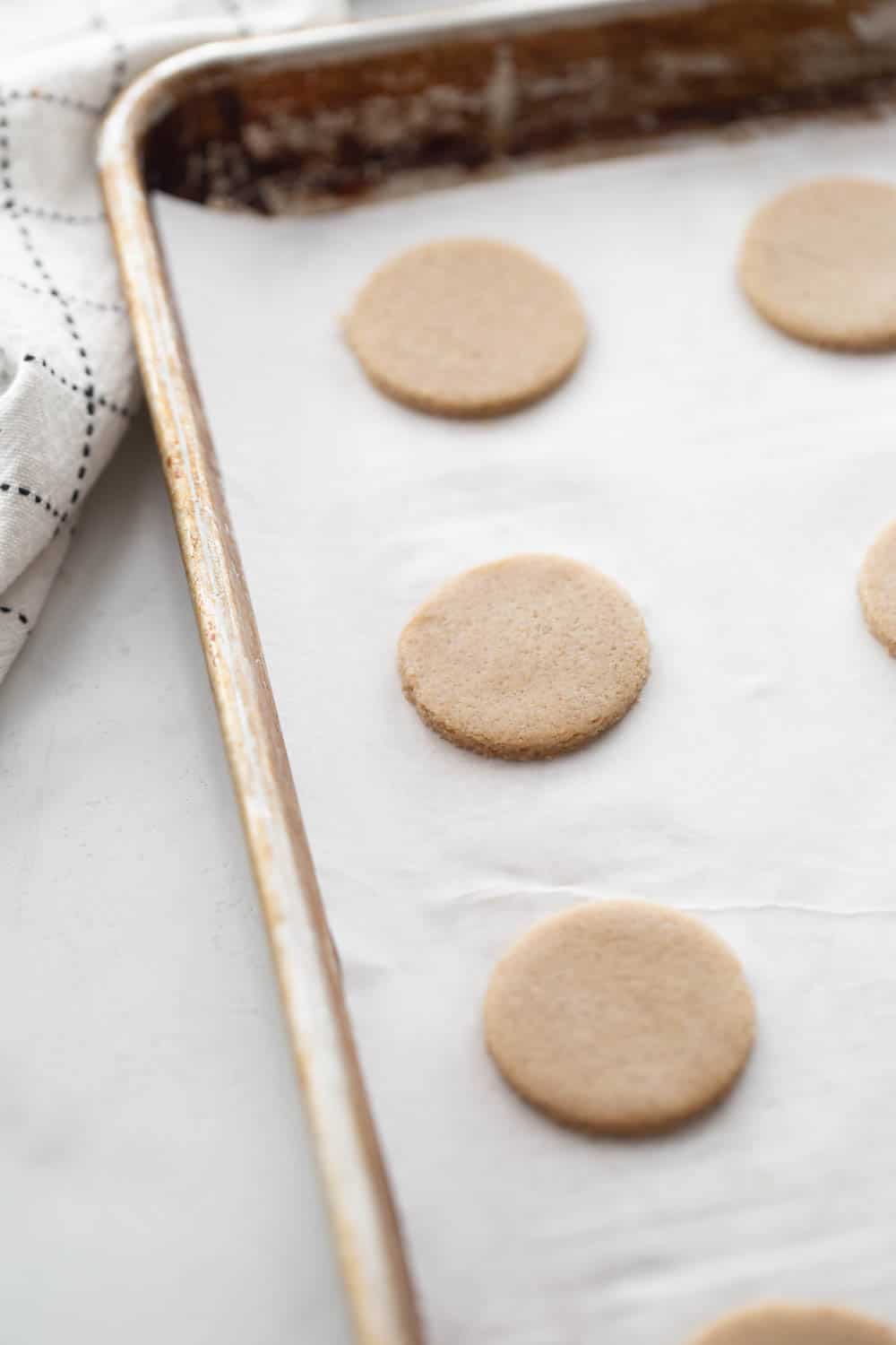 Shortbread cookies on a parchment lined cookie sheet.