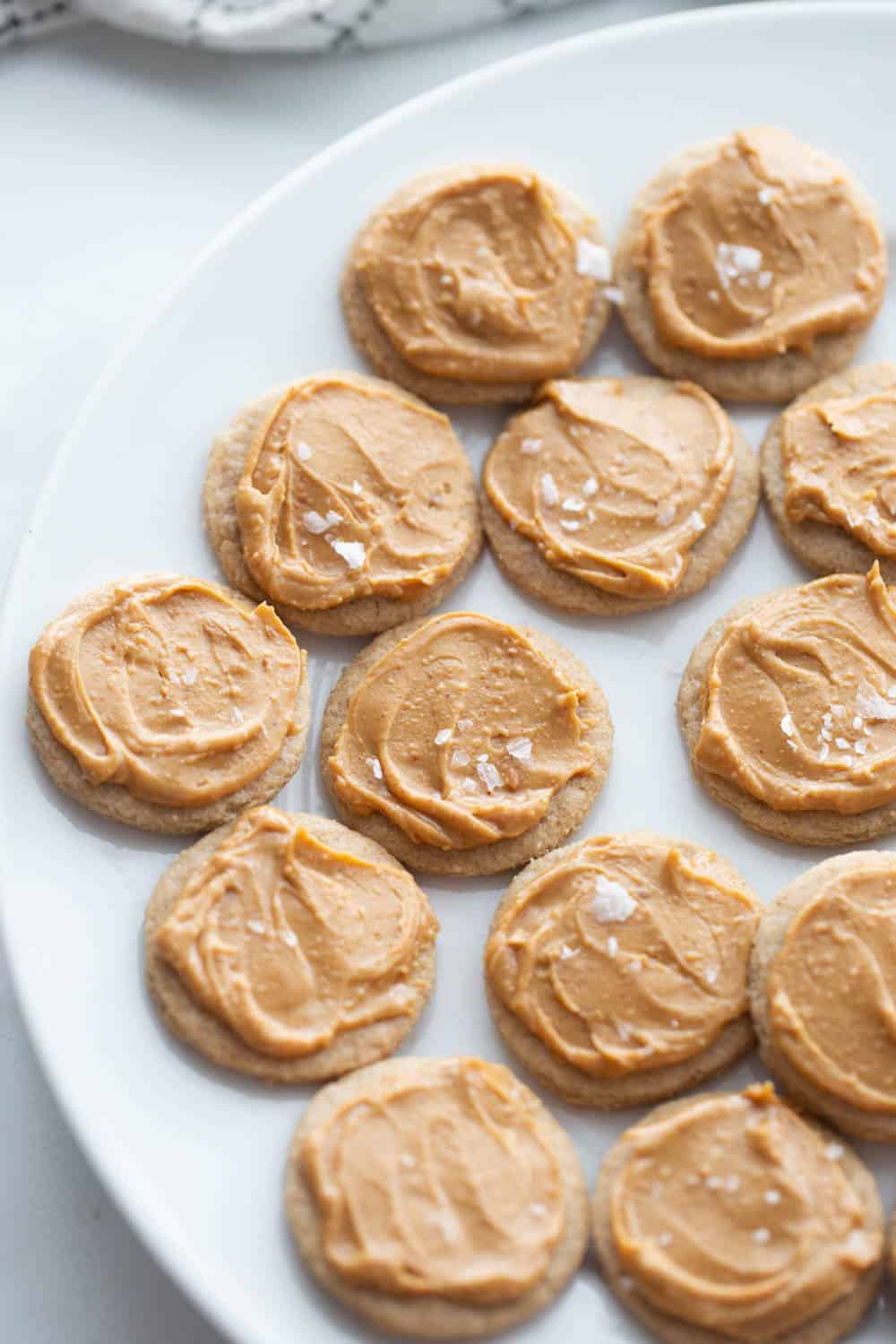 Small shortbread cookies with peanut butter and flakey salt on top.