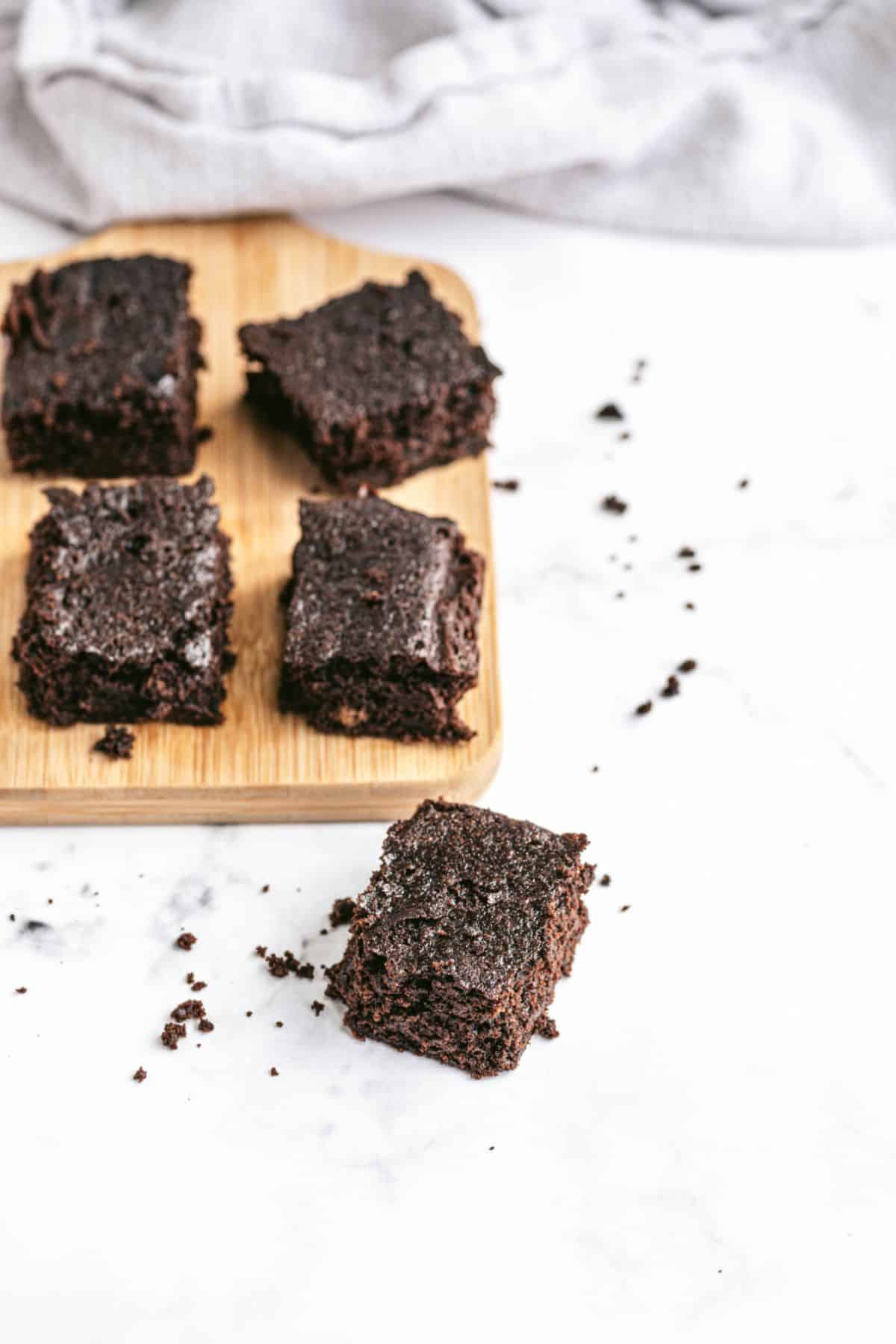 Healthy brownies on a wooden cutting board.