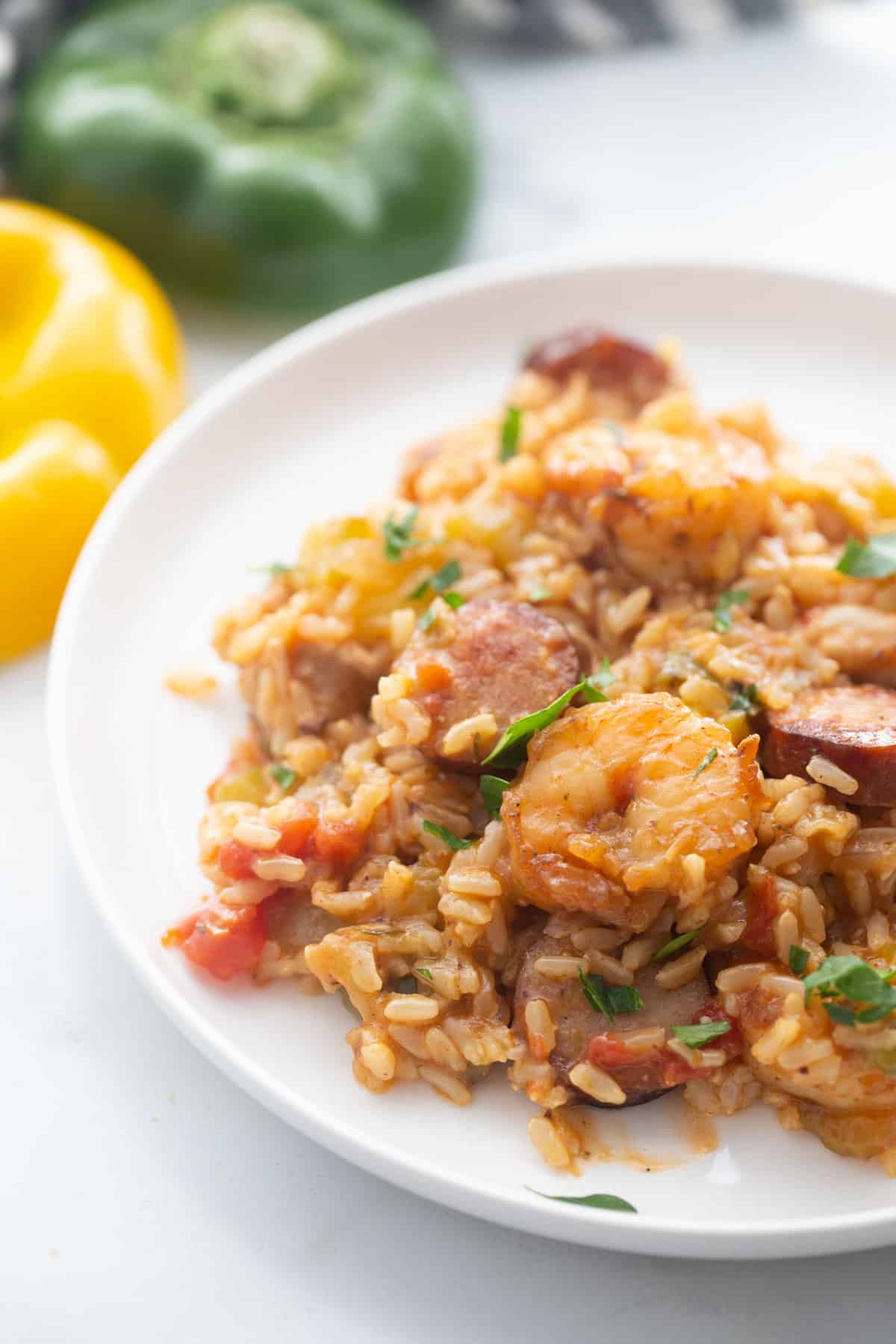 Healthy Jambalaya on a white plate on a marble counter.
