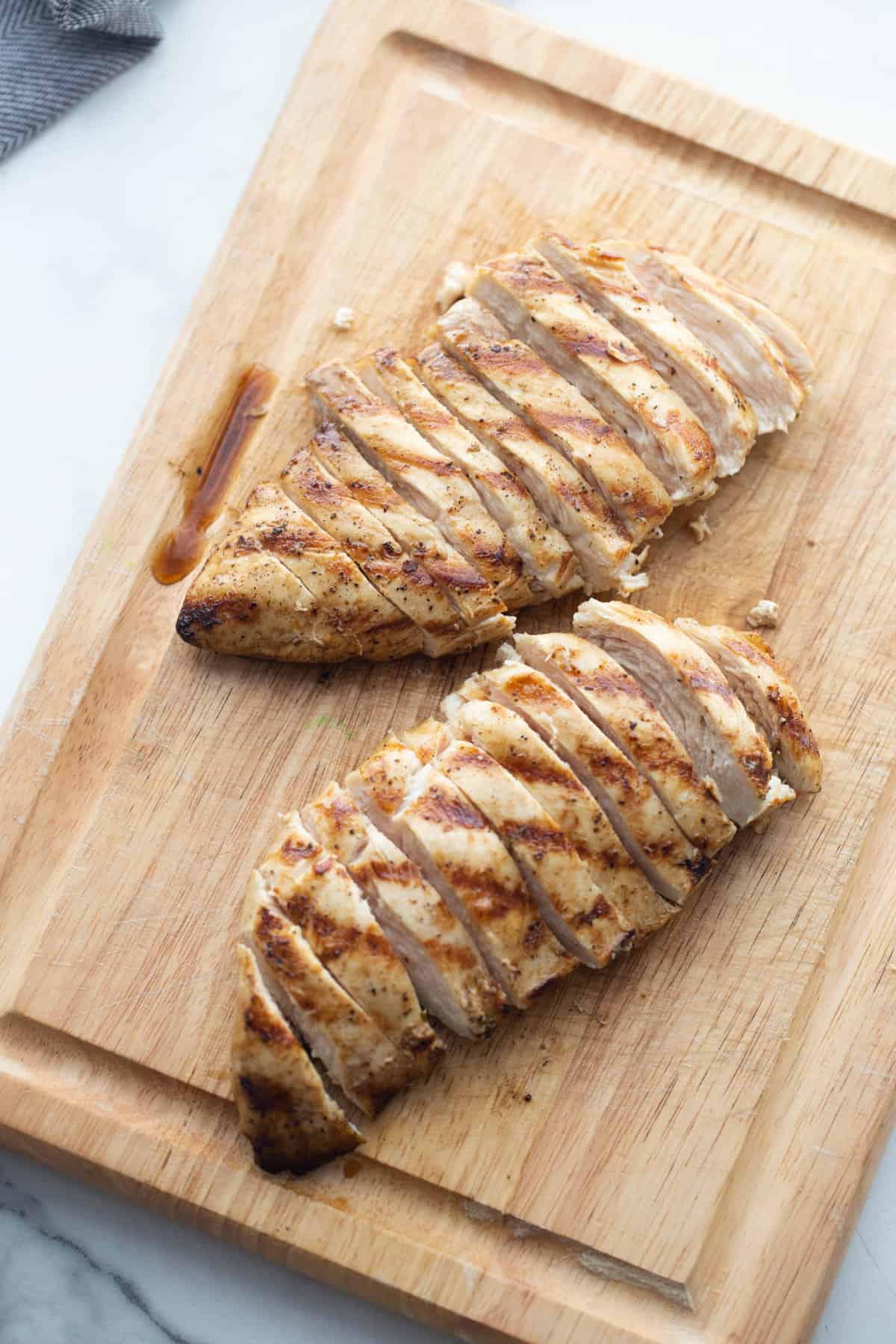 Sliced chicken breast on a cutting board.