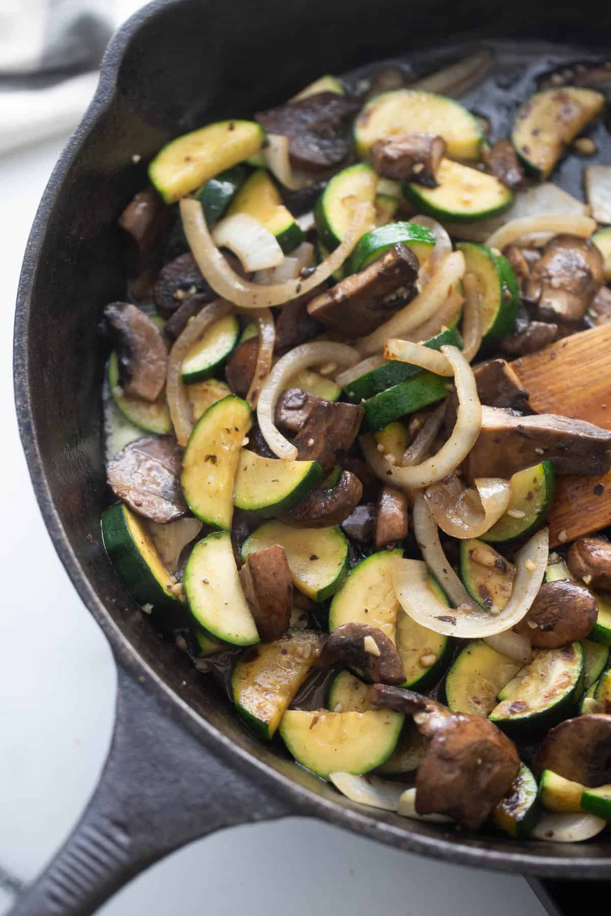 Sauteed zucchini, mushrooms, onions, and garlic in a cast iron skillet.