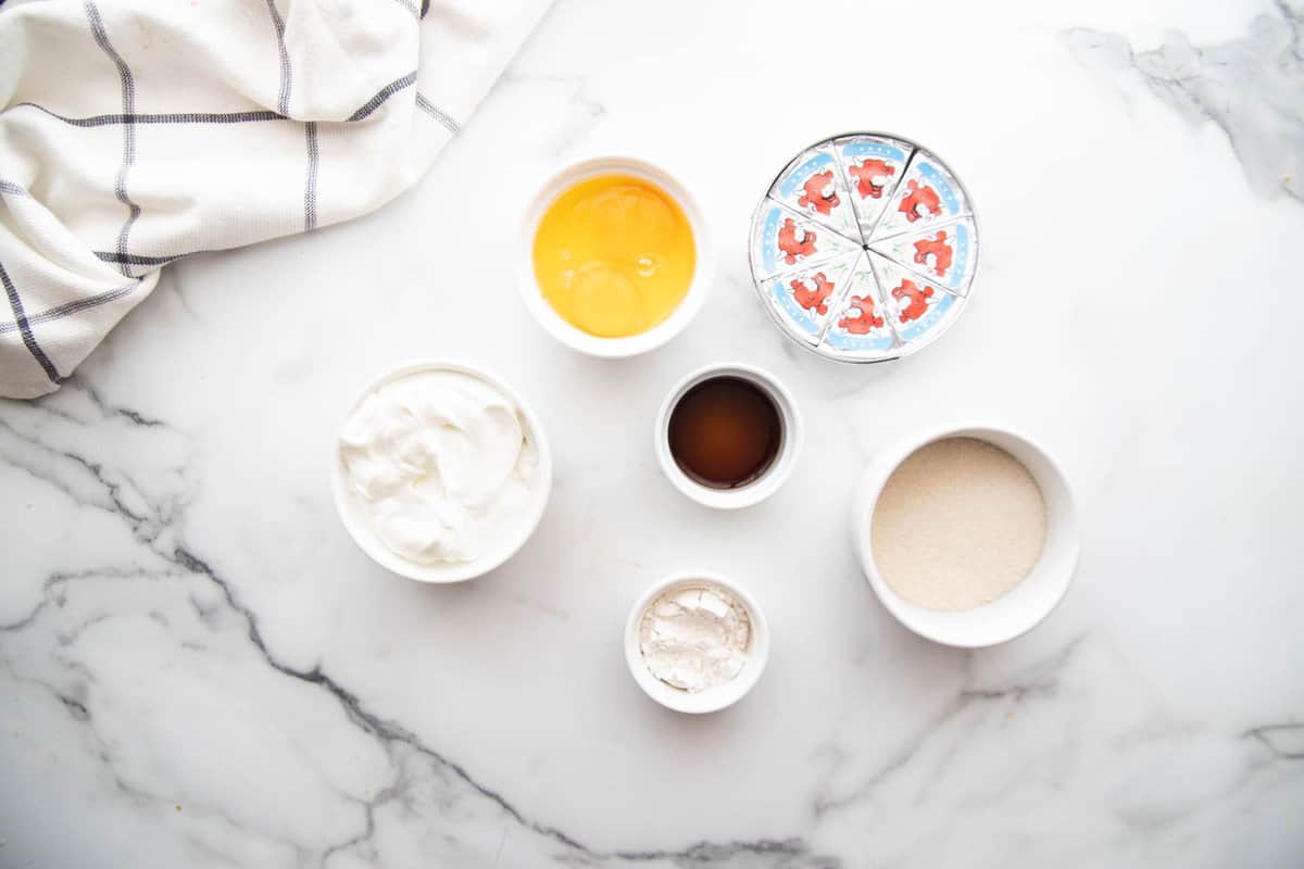 Overhead photo of healthy mini cheesecake filling ingredients on a white countertop.