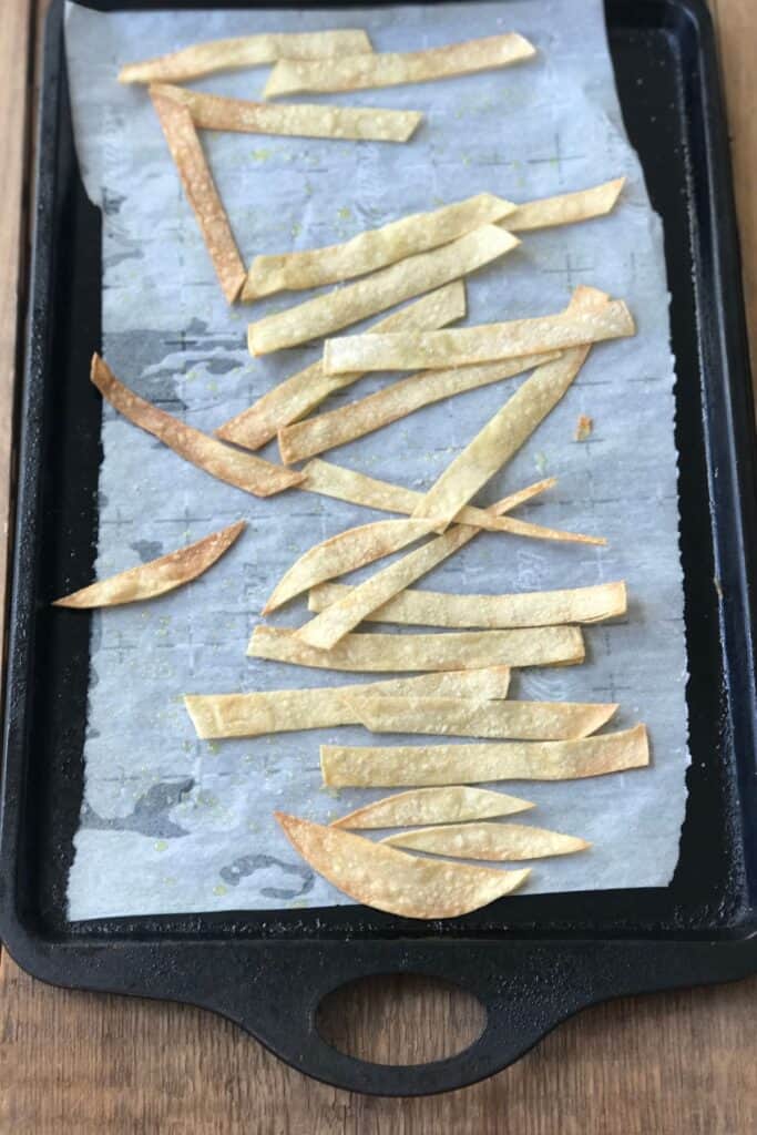 Homemade tortilla chips on a sheet pan.