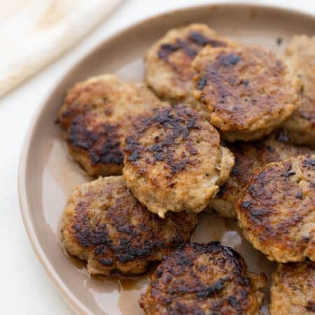 Plate of cooked chicken breakfast sausage patties.