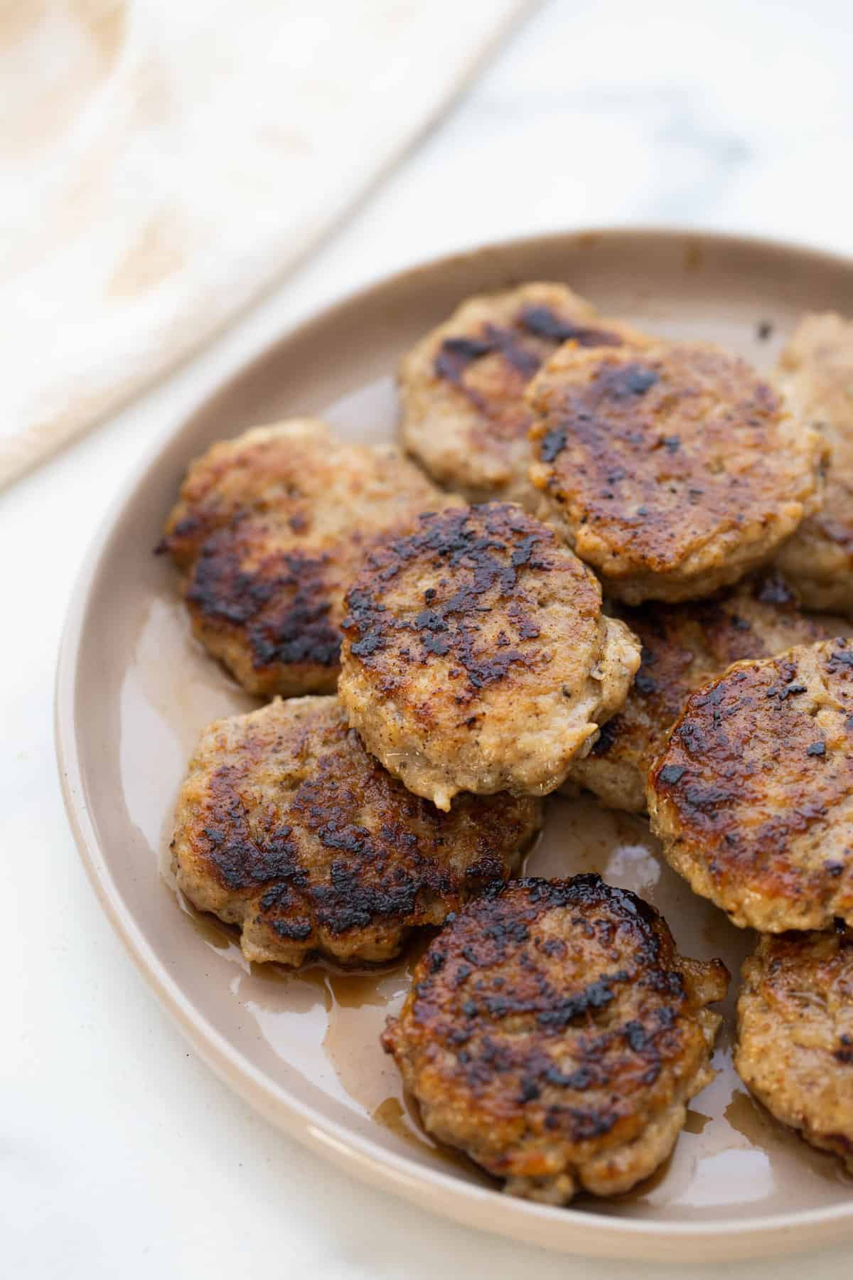 Plate of cooked chicken breakfast sausage patties.
