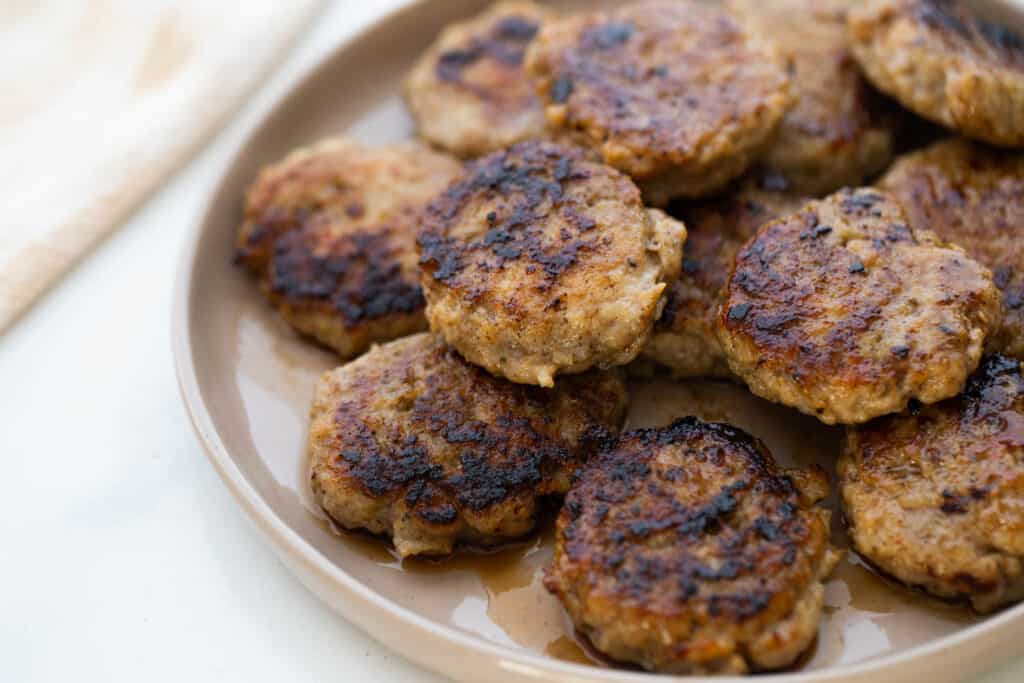 Plate of cooked chicken breakfast sausage patties.