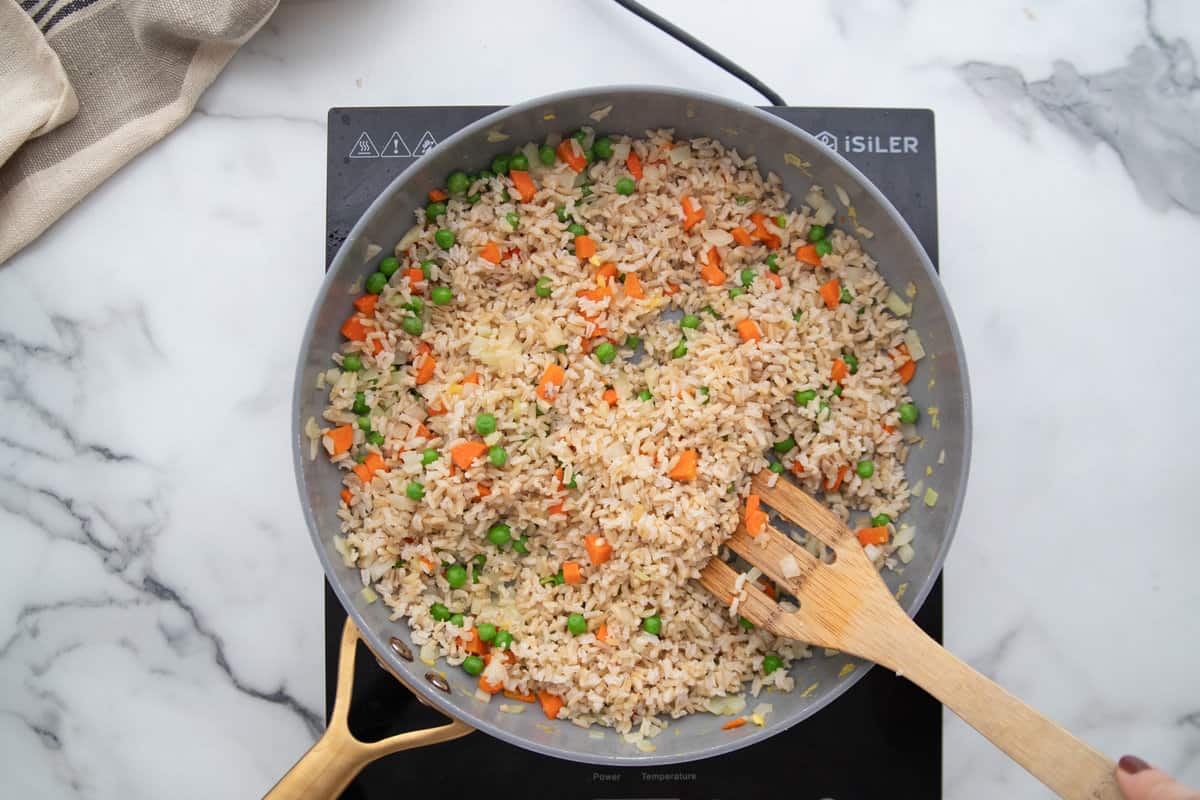 Day old brown rice in a skillet for fried rice.