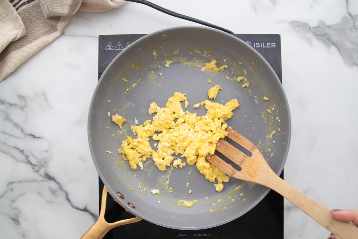 Scrambling two eggs for fried rice in a non-stick skillet.