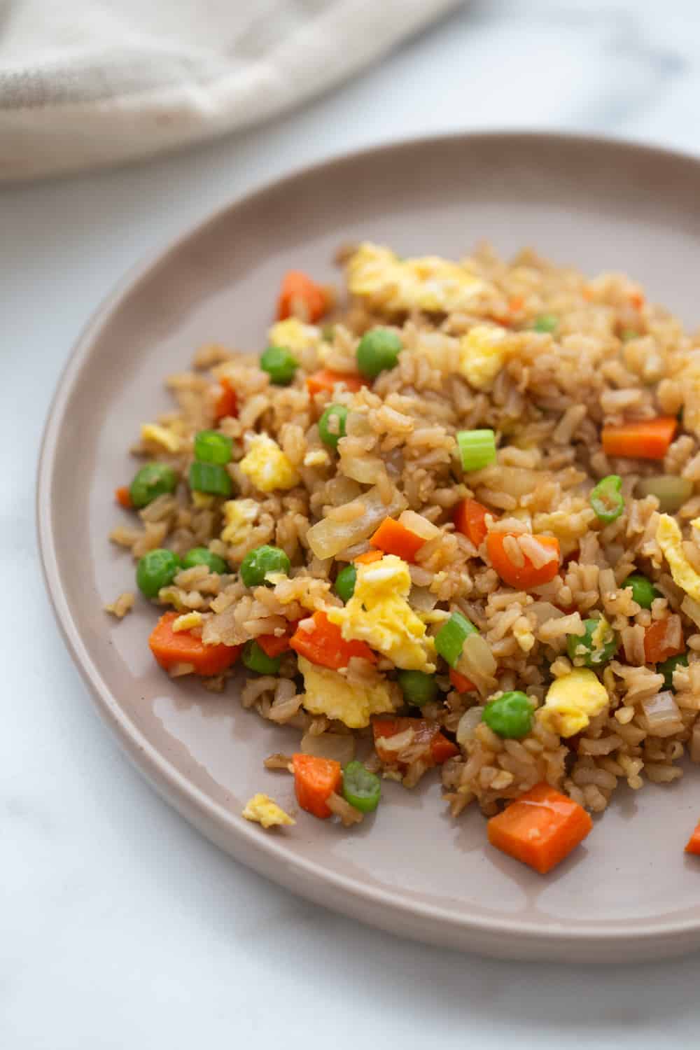 A rimmed plate with healthy copycat fried rice.