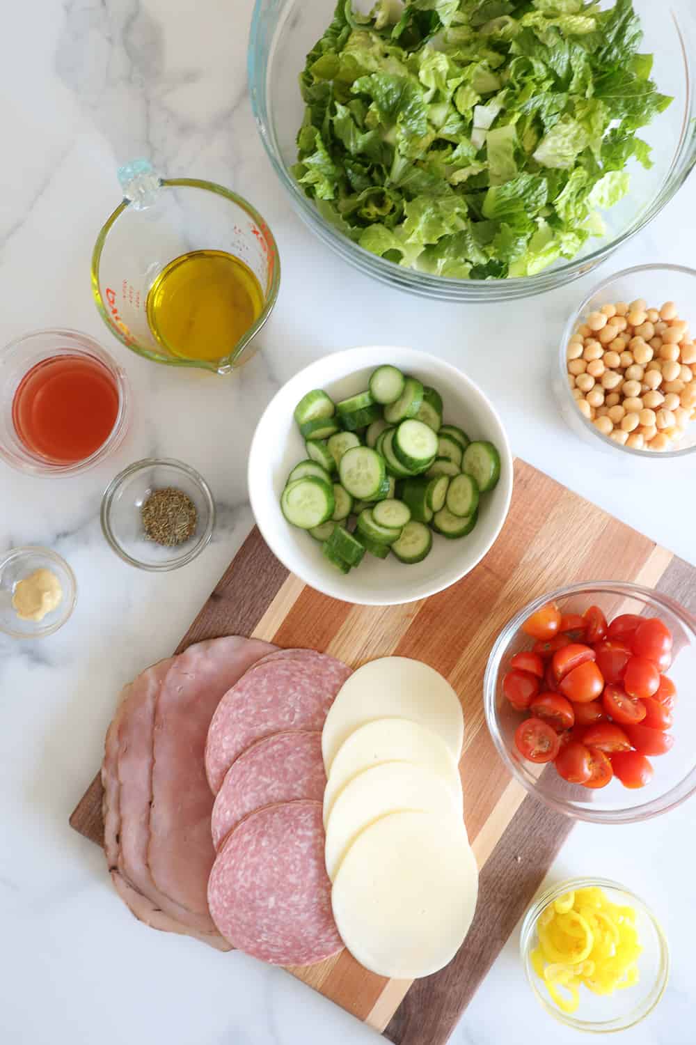 Ingredients for Italian Chopped Grinder Salad on a white countertop
