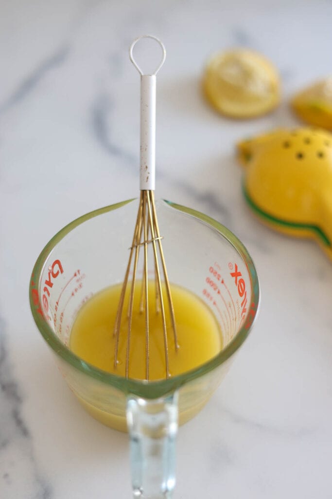 Simple lemon vinaigrette dressing made from olive oil and fresh lemon.