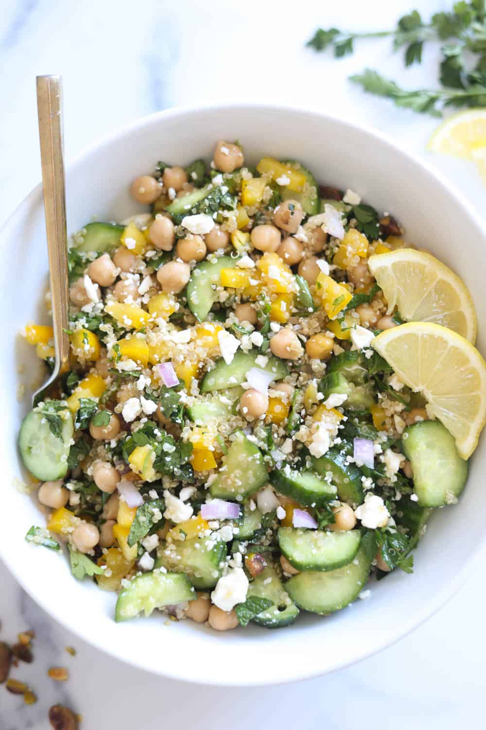 Bowl of the viral Jennifer Aniston Salad with chickpeas, quinoa, fresh veggies, and a lemon vinaigrette.