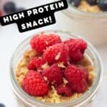 Jars of cottage cheese cheesecake snacks that are high protein and topped with fruit and graham crackers.
