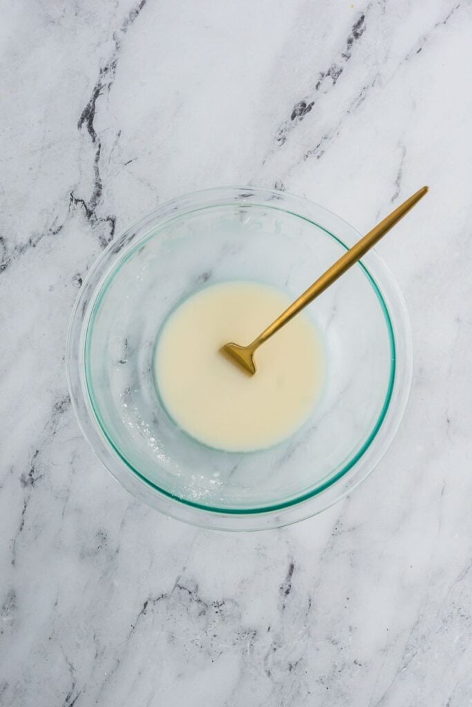 Cornstarch slurry for homemade gravy in a clear glass bowl.