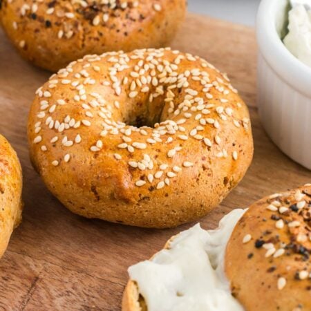 high protein bagels on a wooden cutting board