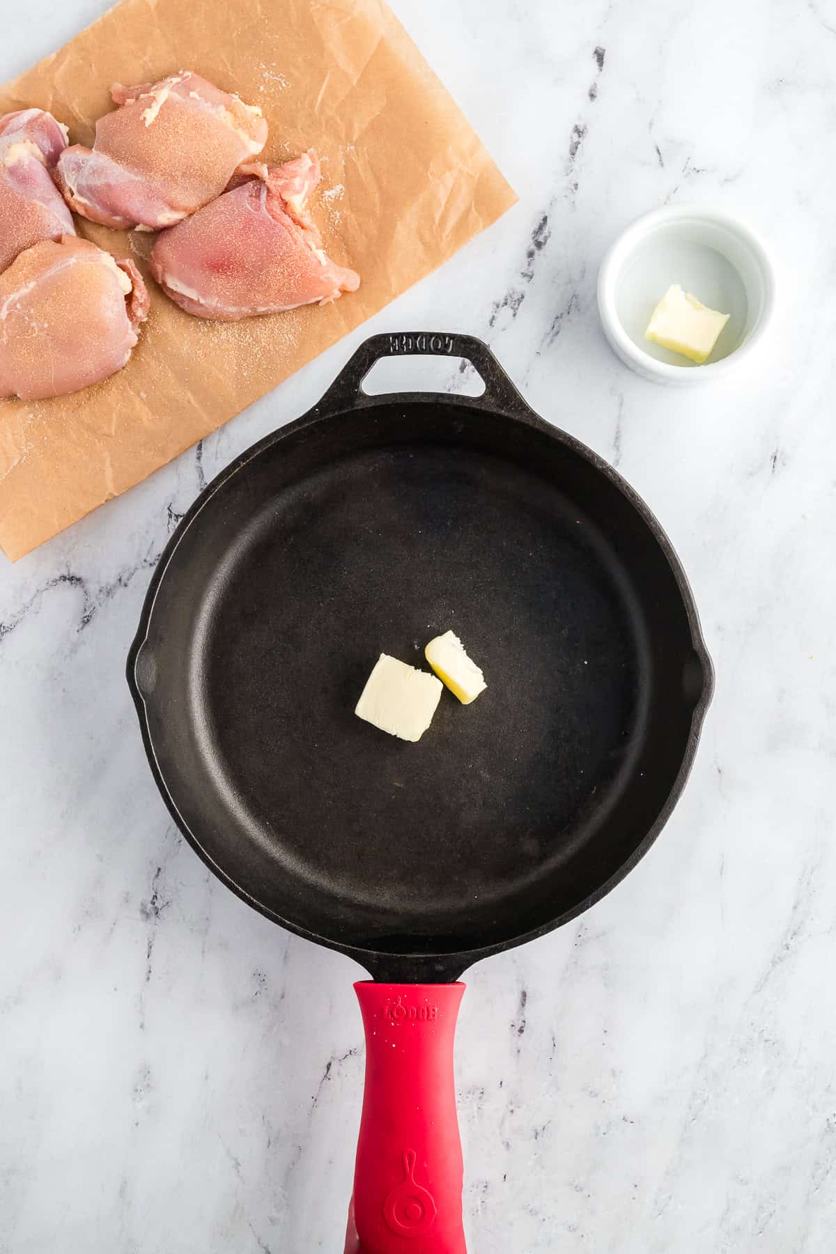 Butter in a skillet before being melted.