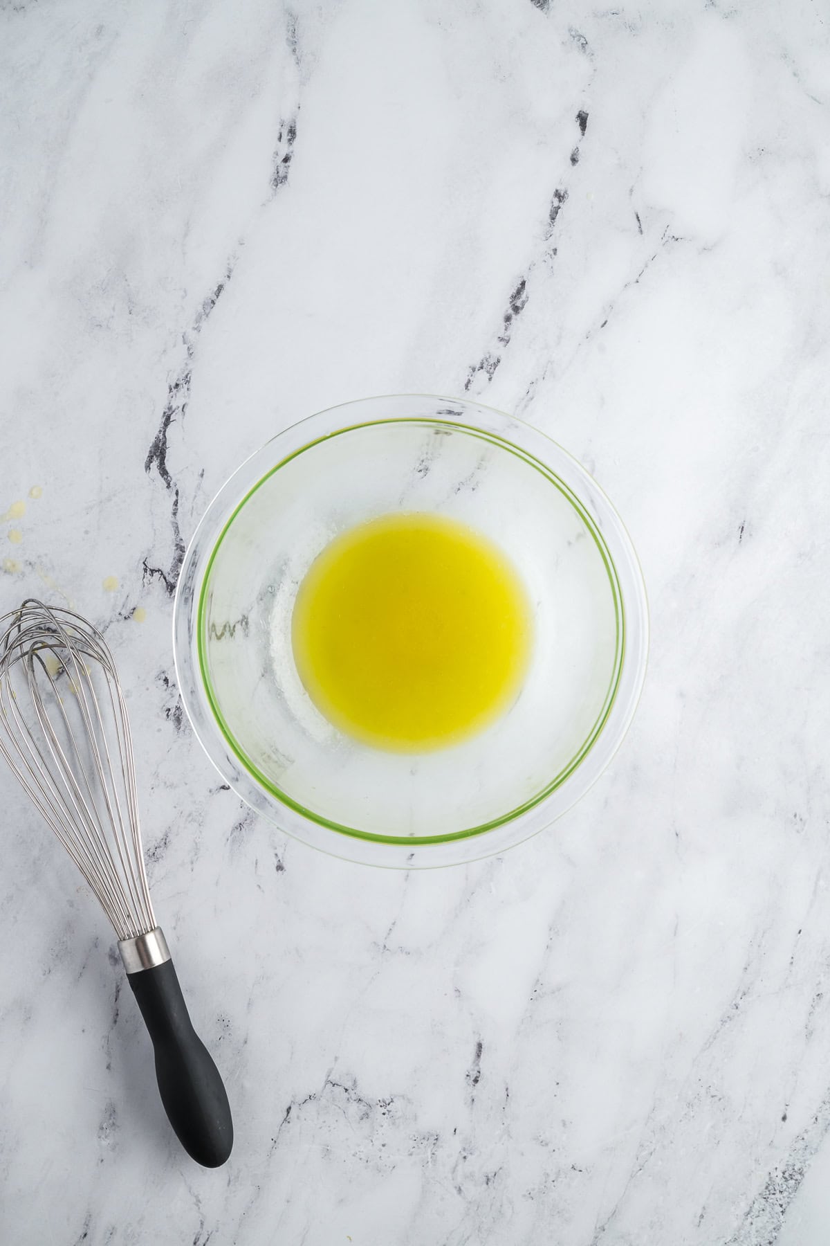 Lemon juice, olive oil, and honey whisked together in a small bowl to make a vinaigrette.