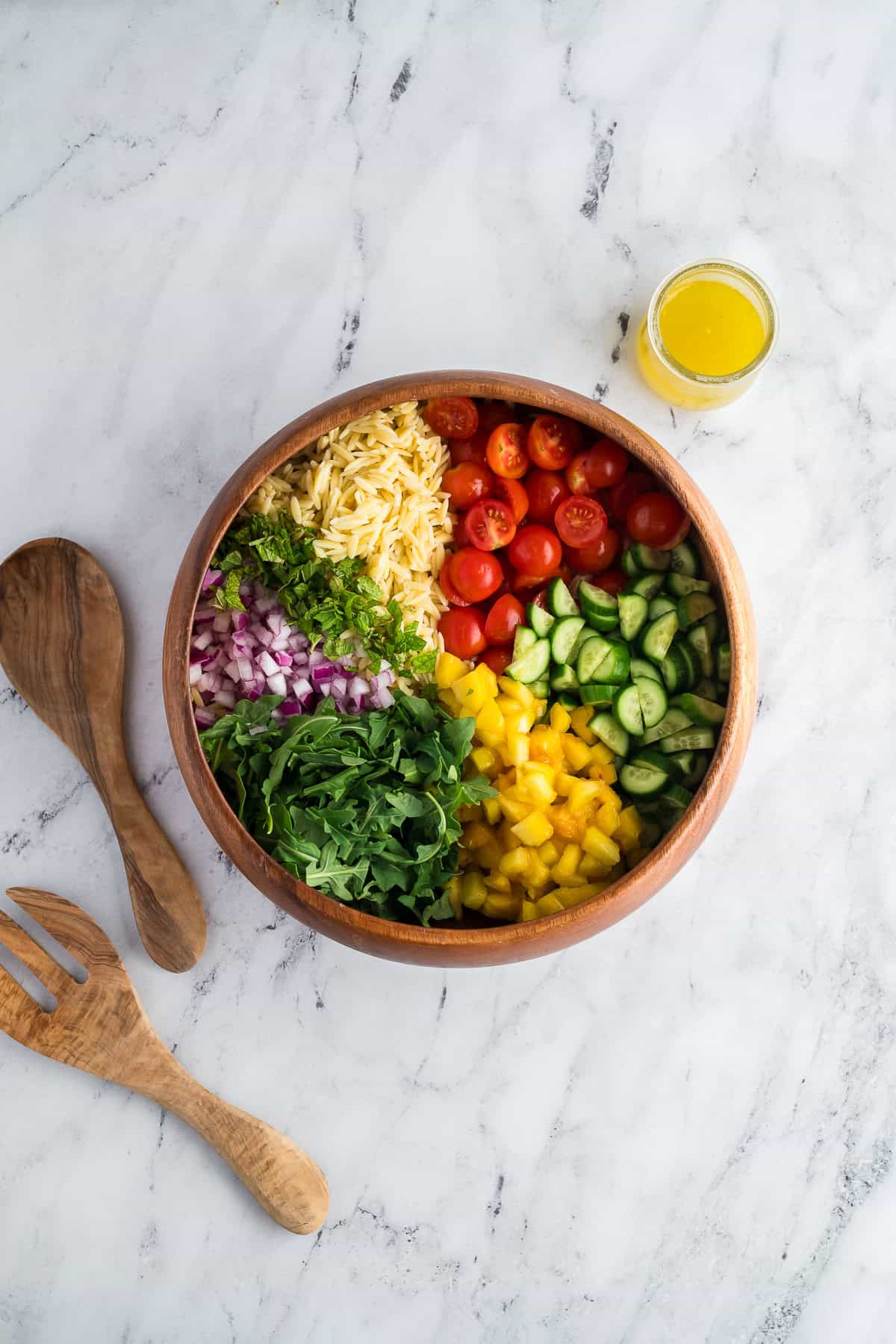 Ingredient in a bowl for summer orzo salad.