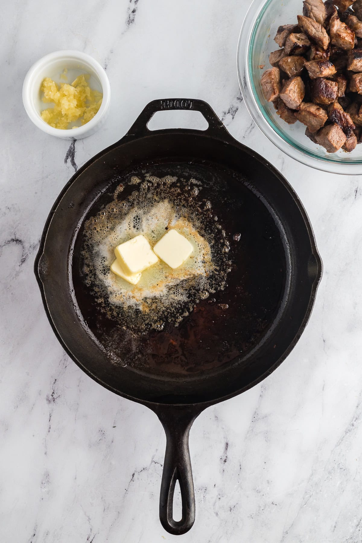 Melting butter in a cast iron pan. 