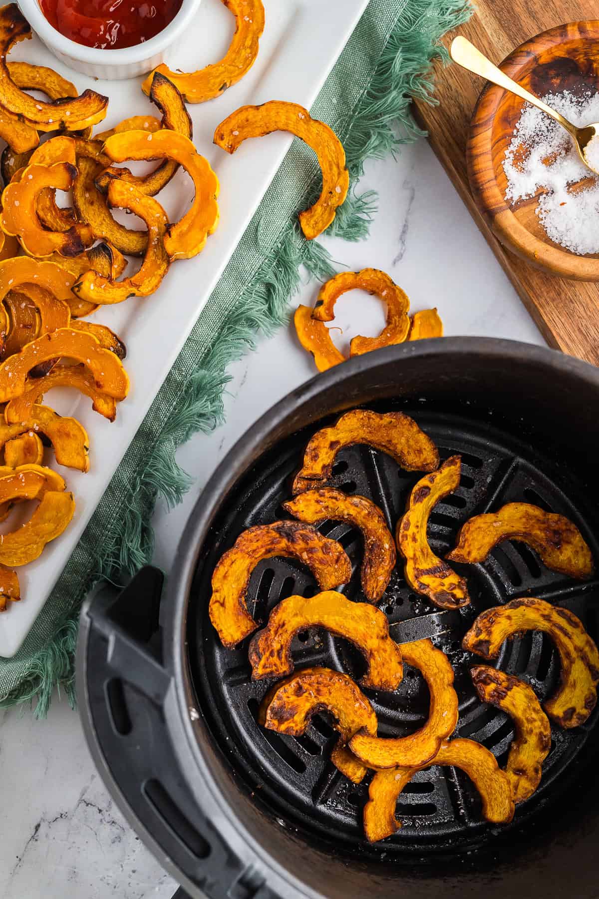 Crispy Air Fryer Delicata Squash on a marble countertop.