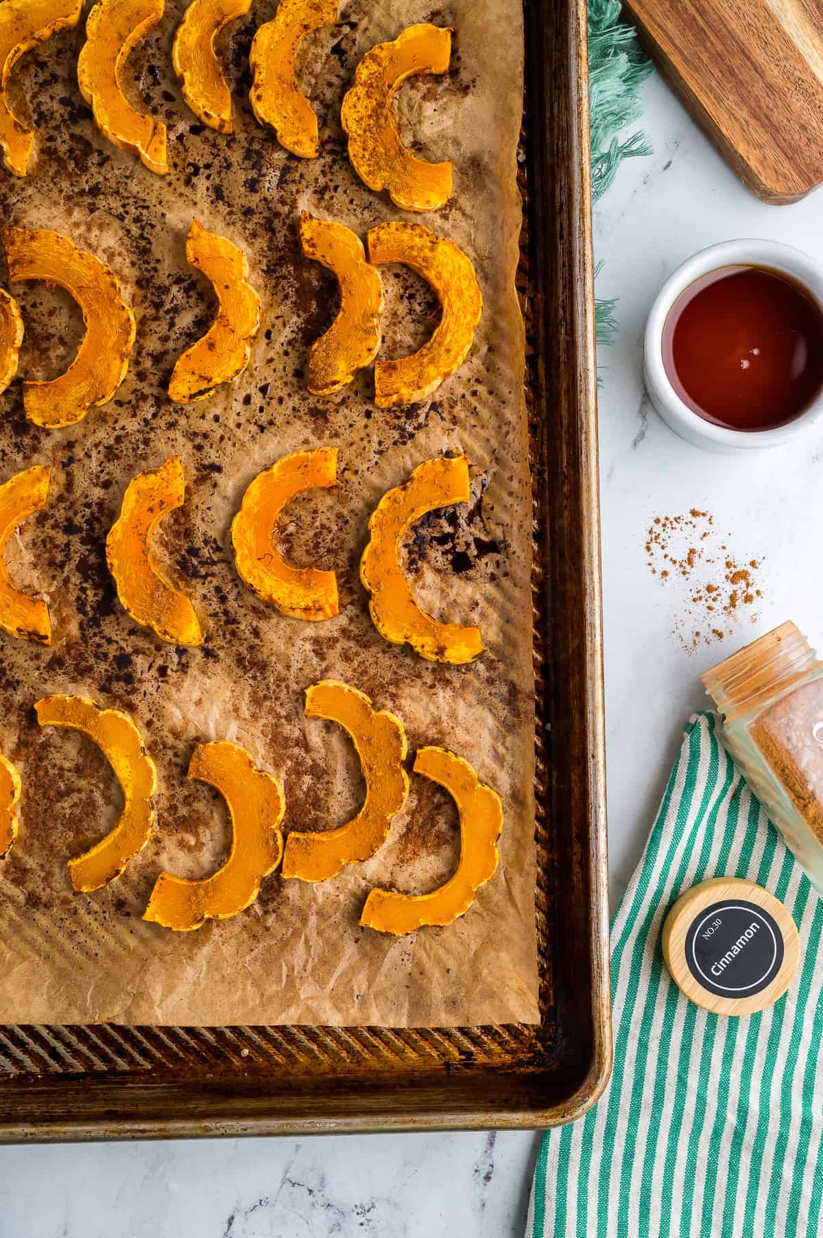 Roasted delicata squash on a baking sheet.