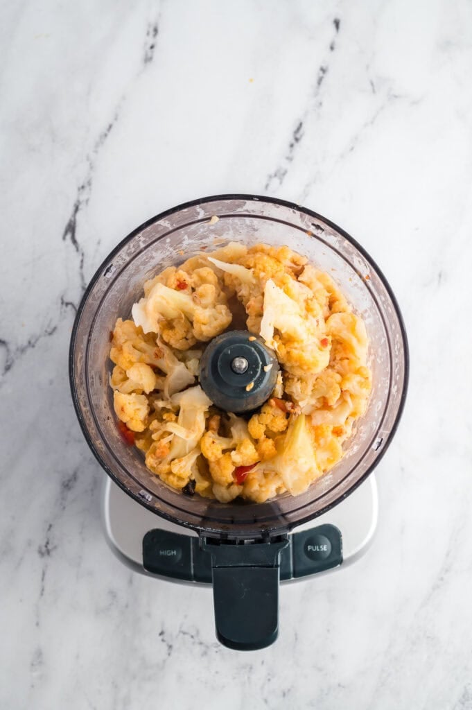 Steamed cauliflower florets in a food processor.